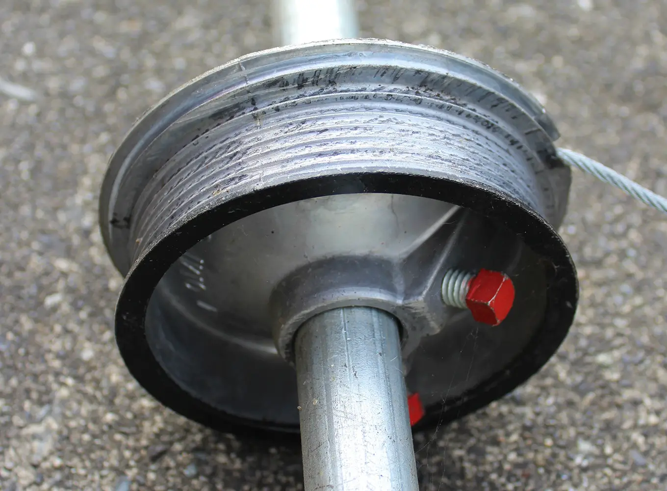 garage door cable and cable pulley on the ground