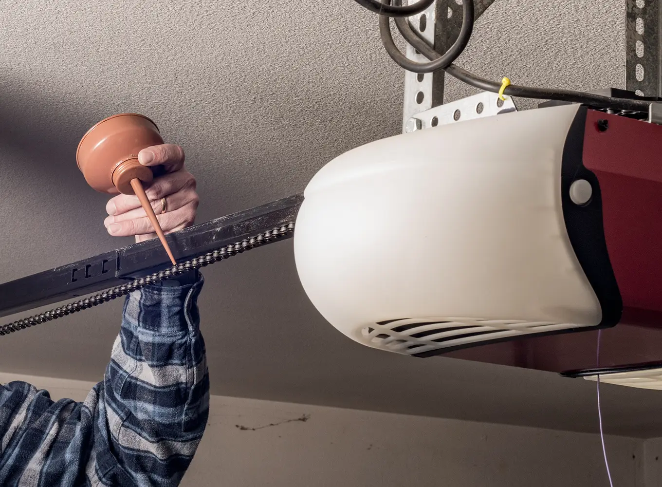 garage door company lubricating garage door chain link with oil - Edwardsville IL