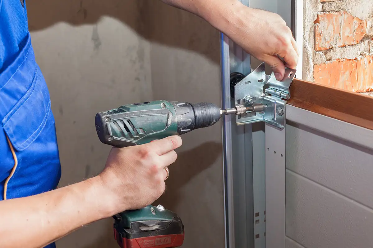 Tri County Garage Door Company—A professional technician installs a new garage door at a residential home in Edwardsville, IL.